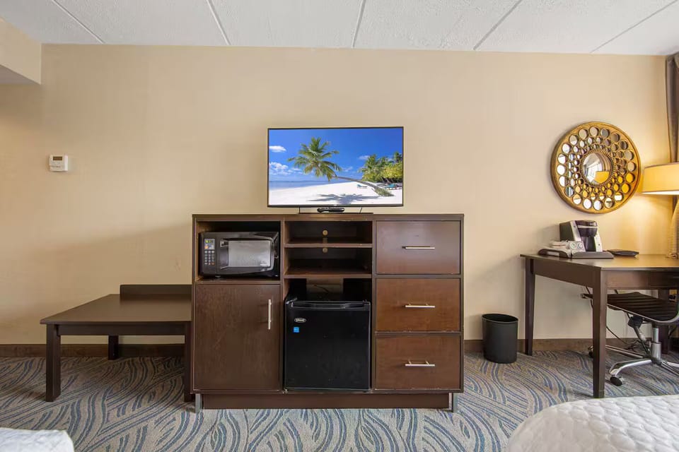 Modern entertainment area with TV, mini fridge & microwave for relaxing stays