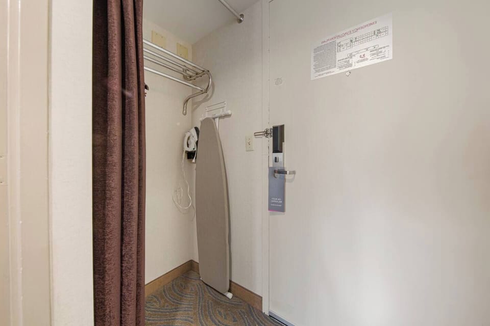 Entryway with open closet, luggage rack & ironing station for travel ease