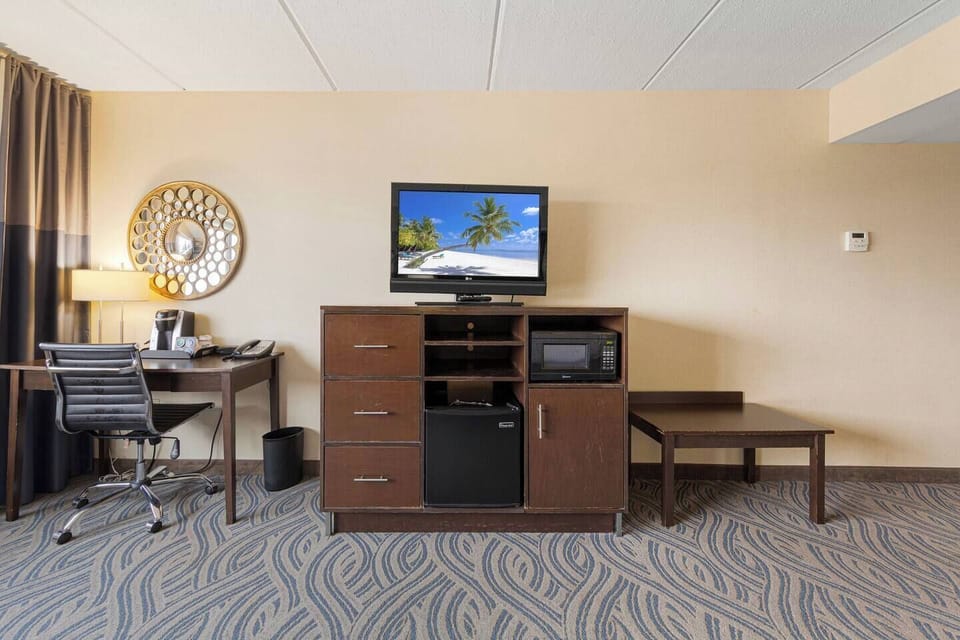 Modern entertainment area with TV, mini fridge & microwave for relaxing stays
