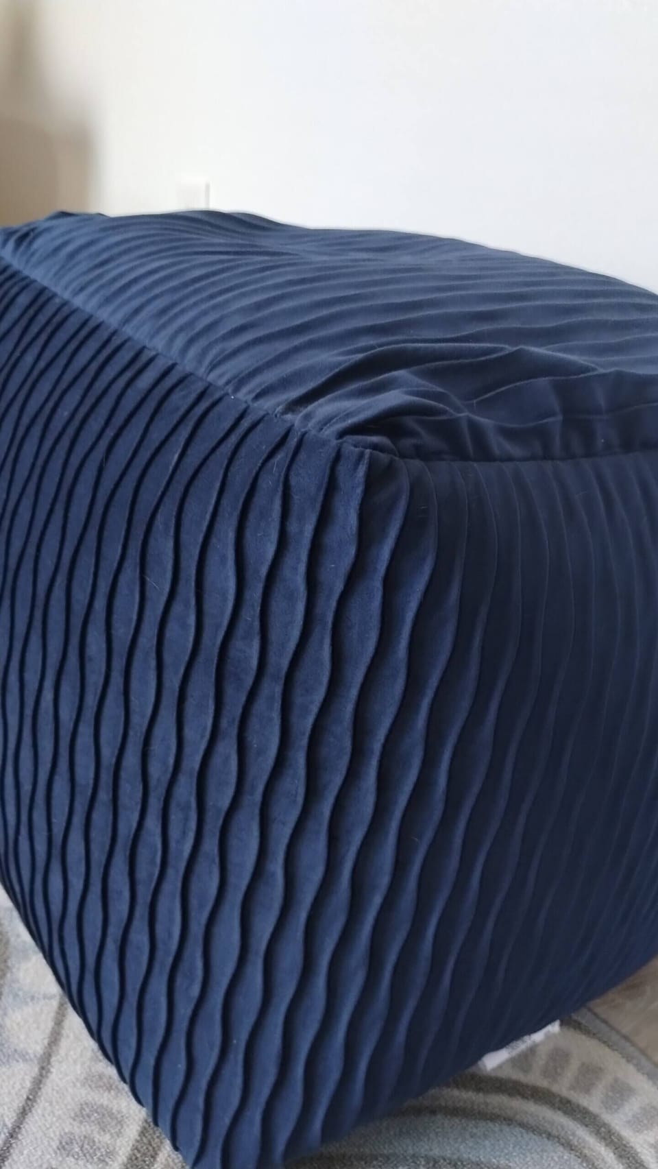 Footstool/seat in living room.