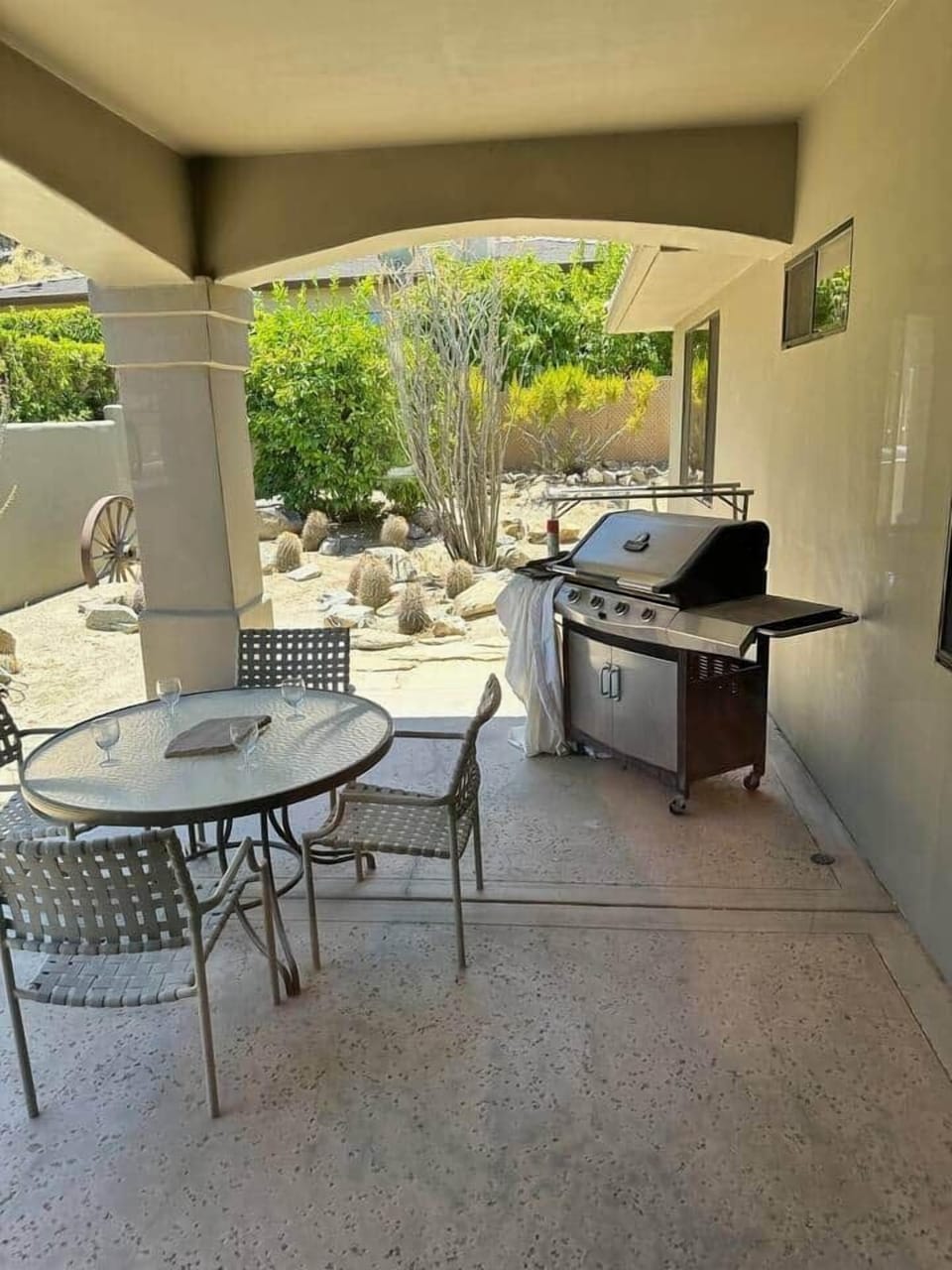 Side Patio with dining table and propane grill