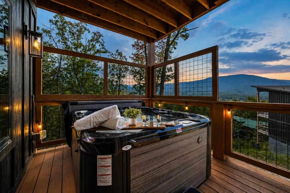 Private covered hot tub deck with glowing mountain sunset views