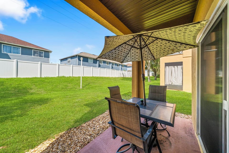 Another patio angle showing generous shaded space and outdoor seating.