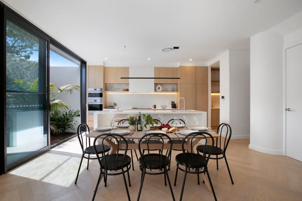 Gather around the dining table for shared meals, with the spacious kitchen conveniently close by.