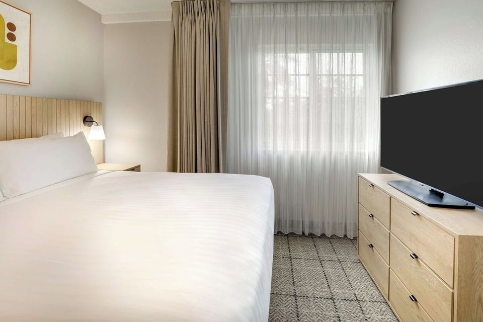 Drift off beside soft window light and calming neutral tones.
