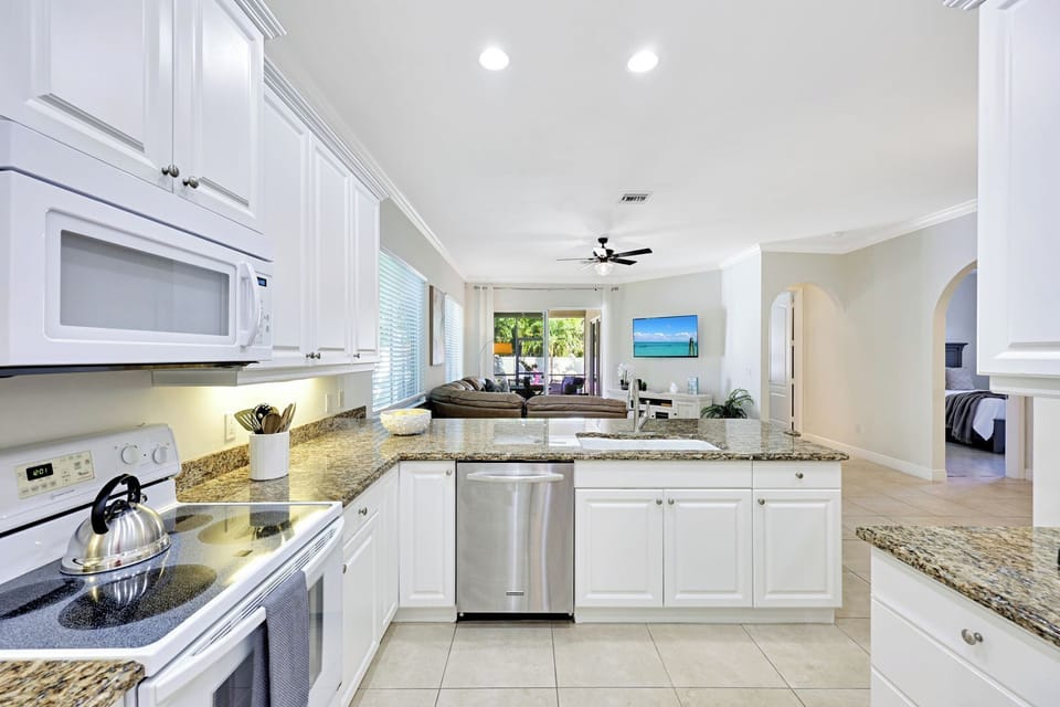 Cook, chat, and stay connected — all while enjoying clear sightlines to the lanai and pool