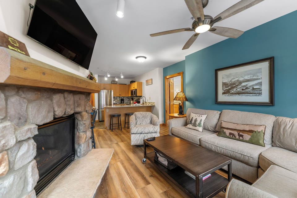 Cozy up in your mountain retreat with a crackling stone fireplace, comfortable seating, and warm wood accents throughout.