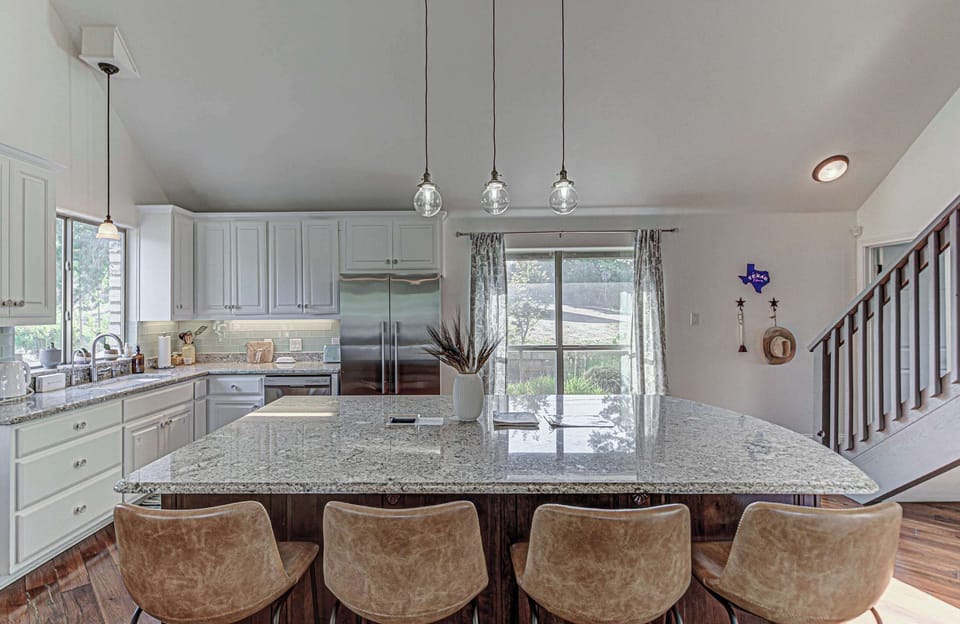 Chef's kitchen with granite counters and stainless appliances 