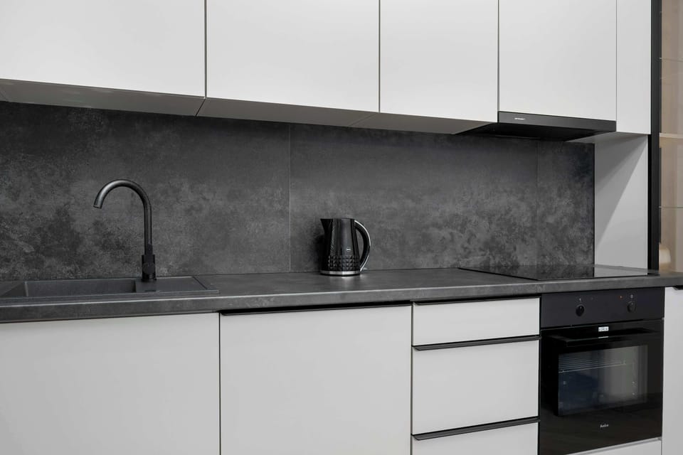 The sleek design of the kitchenette blending seamlessly with the living area.