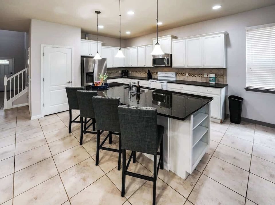 Prepare delicious meals in our fully equipped kitchen with a spacious island, perfect for cooking and casual dining
