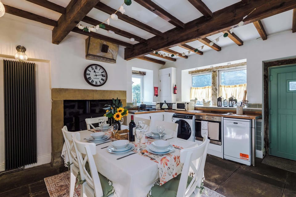 The bright, homely kitchen is fully equipped for your stay, combining convenience with charm. With original wooden beams and a welcoming log burner, it’s the perfect spot to cook, dine, and relax in a cozy cottage atmosphere.