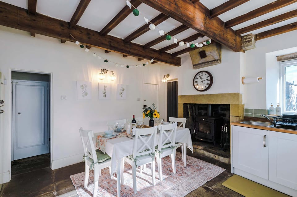 The bright, homely kitchen is fully equipped for your stay, combining convenience with charm. With original wooden beams and a welcoming log burner, it’s the perfect spot to cook, dine, and relax in a cozy cottage atmosphere.