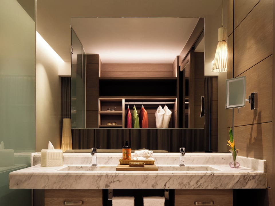 Refresh in a spa-like bath with marble vanity and soft glow.