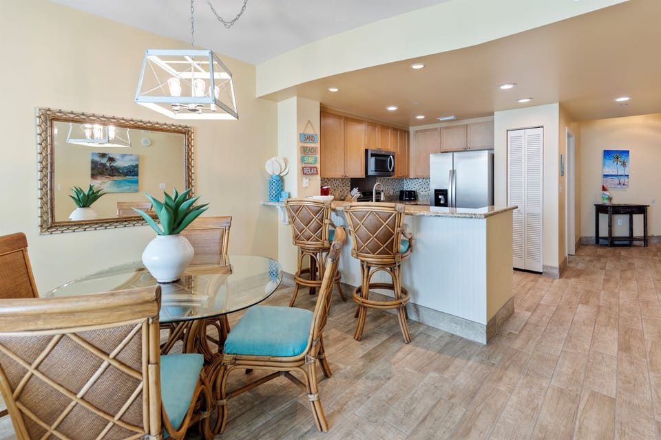 Your open-concept kitchen flows seamlessly into dining space, featuring modern appliances and tropical touches that create the perfect coastal retreat atmosphere.