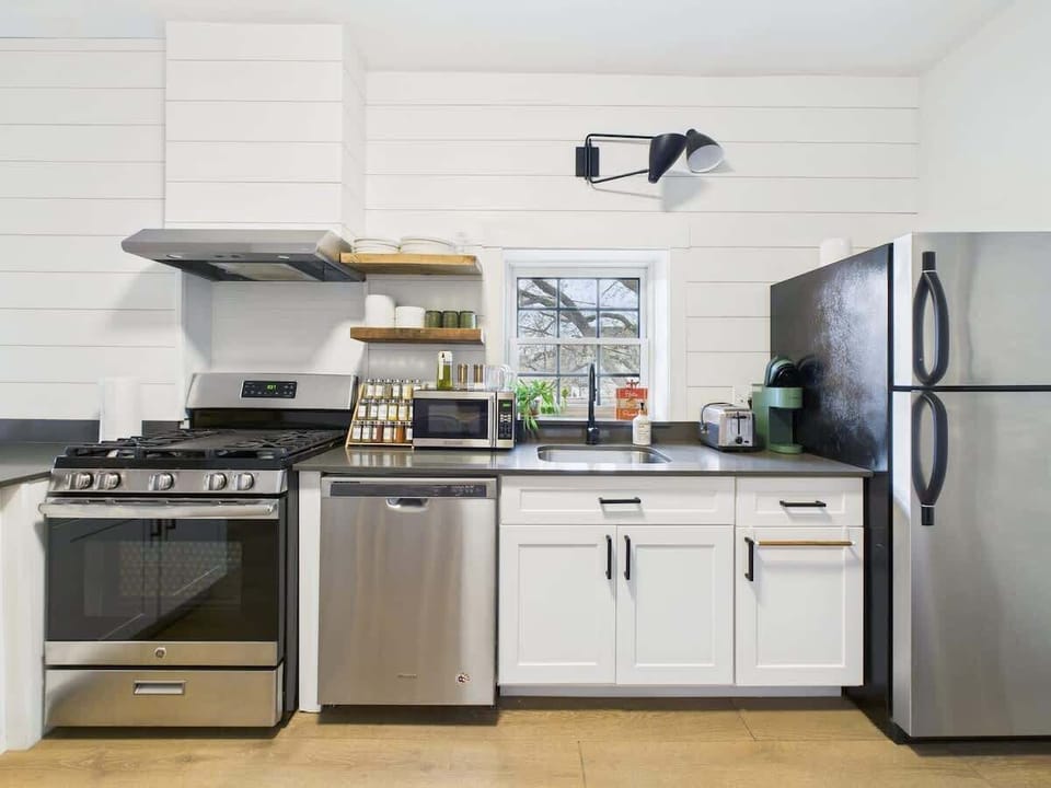 Kitchen: Modern appliances and bright windows set the stage for culinary adventures!