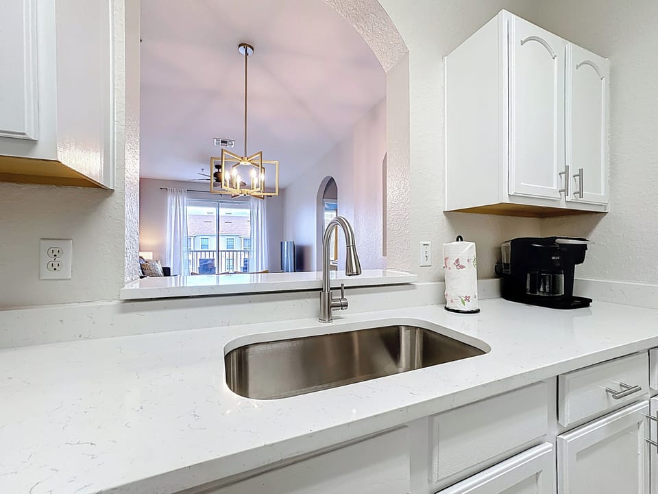Kitchen includes many modern amenities, all stainless steel appliances, quartz 