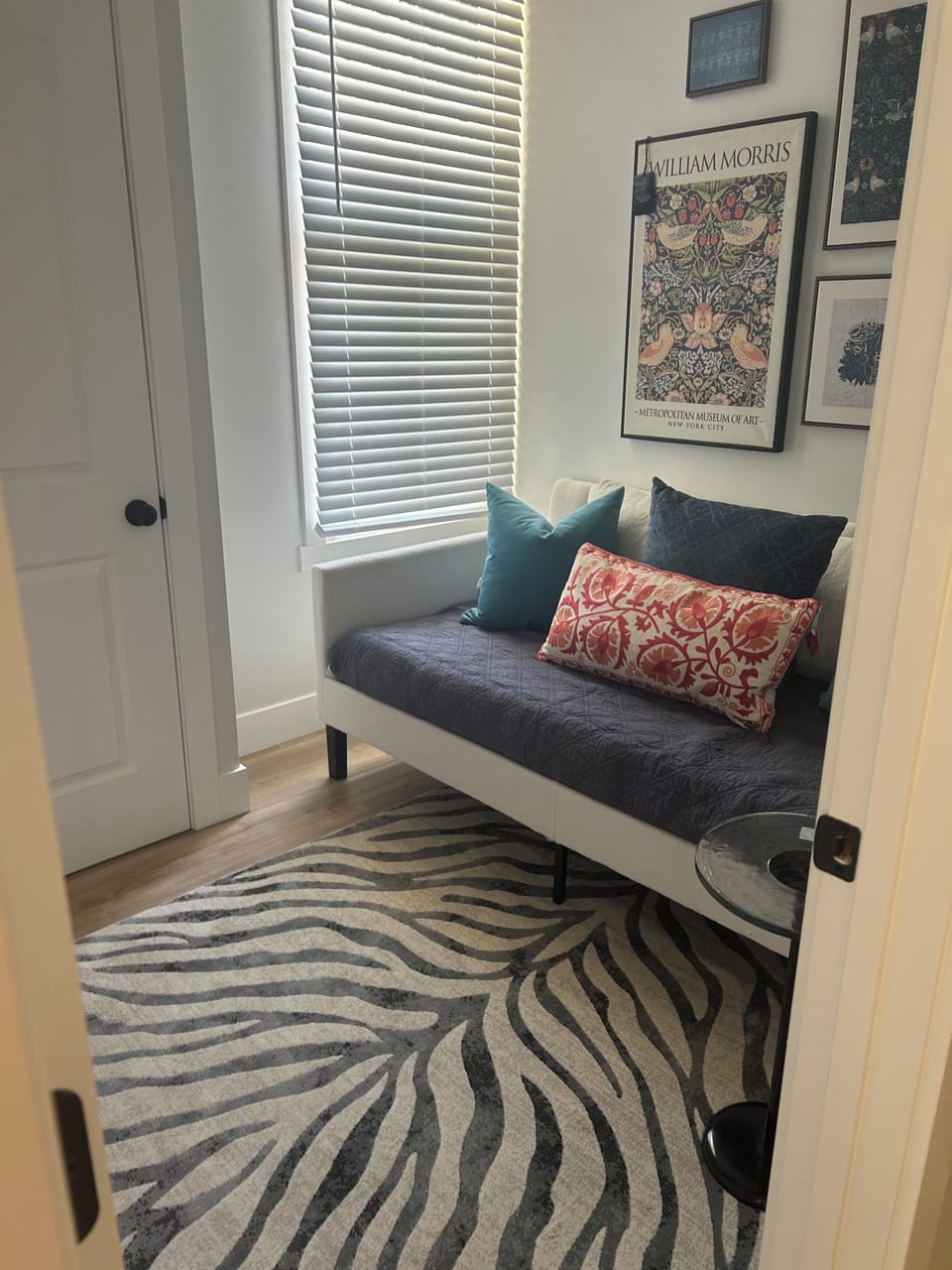 Office with twin daybed, desk, wall-mounted TV