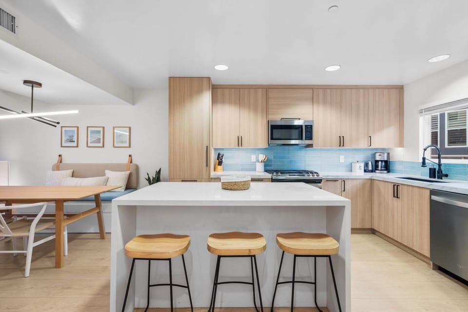 The waterfall-edge island seats three for casual breakfasts and late-night snacks