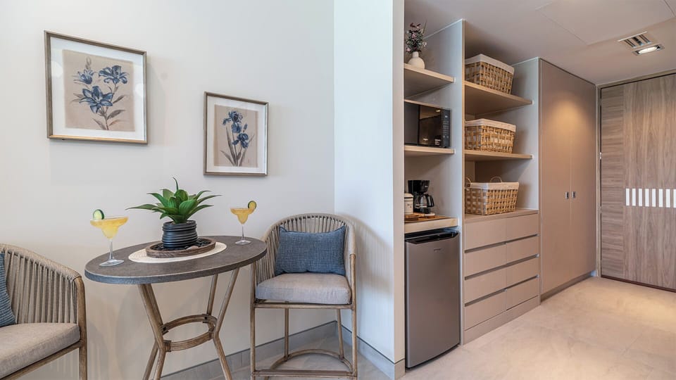 The dining table is next to the kitchenette area