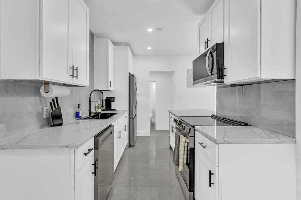 Kitchen comes with plates, cups, cook ware and utensils.