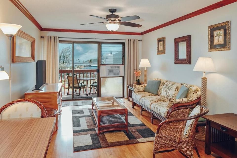 Relax in the airy living room with breezy balcony views.