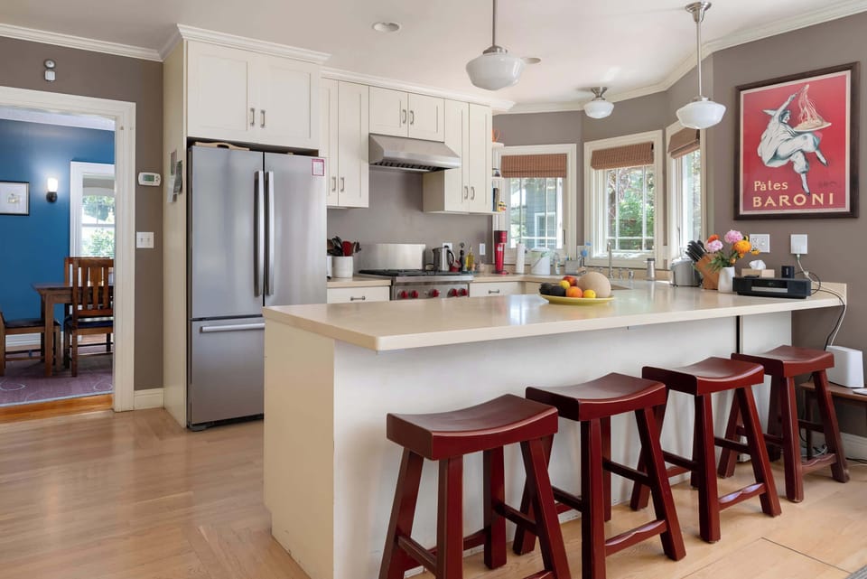The kitchen has a breakfast counter, complete with stools.