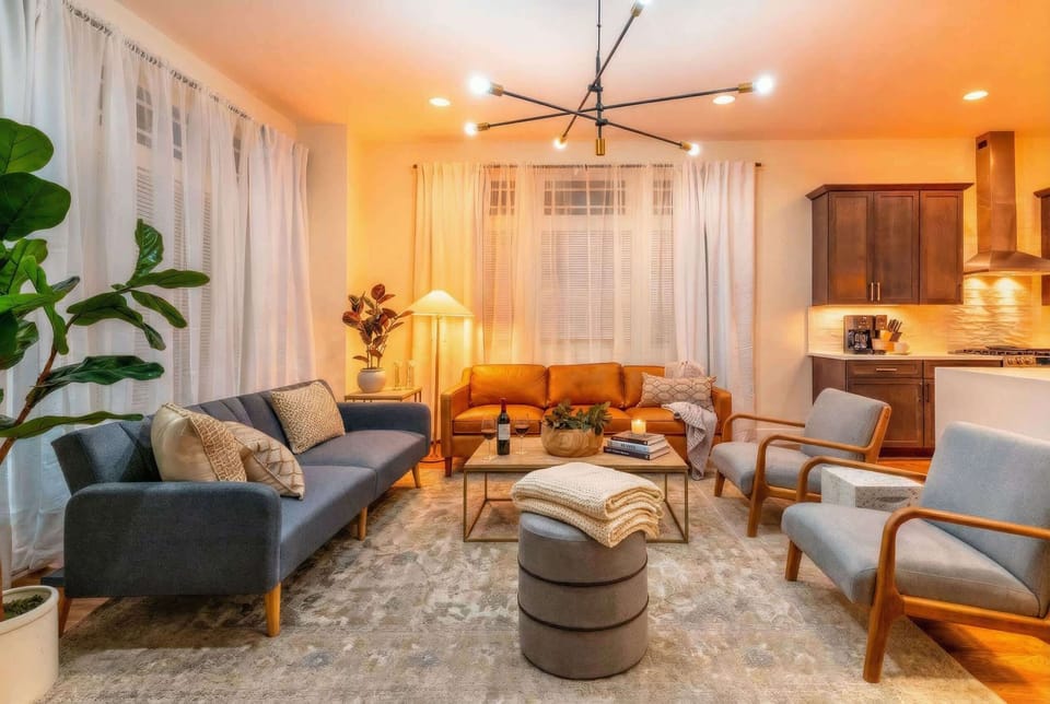Large windows flood the living room with light, while two sofas and armchairs create natural clusters so your group splinters into smaller conversations without leaving the space