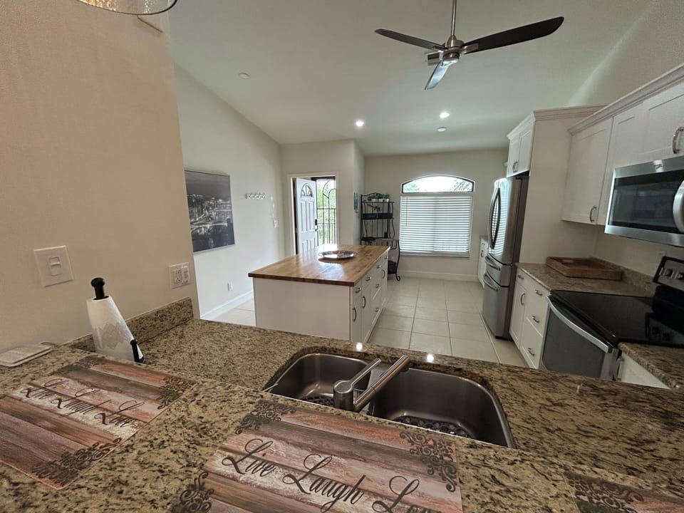 large kitchen with stainless appliances including under-counter dishwasher 