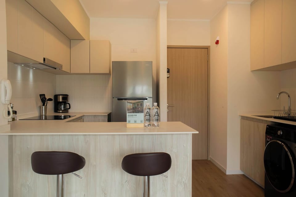 Kitchen counter with bar stools.