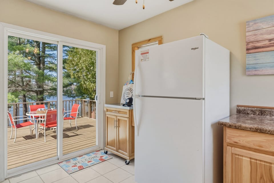 Kitchen with easy deck access, lake views, and a sunny outdoor spot for morning coffee or relaxed meals by the water.