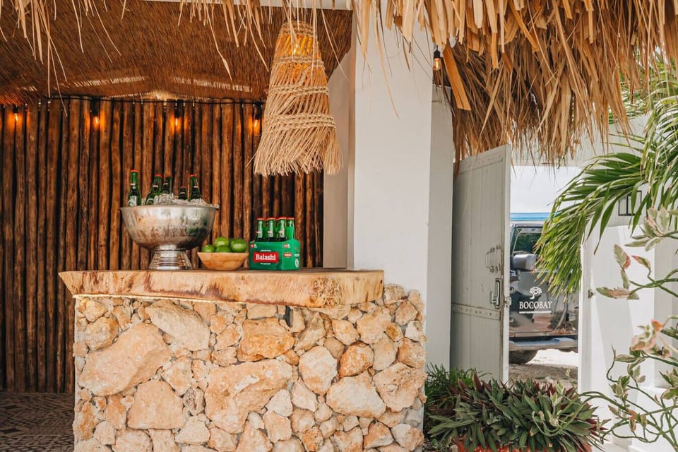 Enjoy a drink in the amazing outdoor pool side tiki bar and palapa
