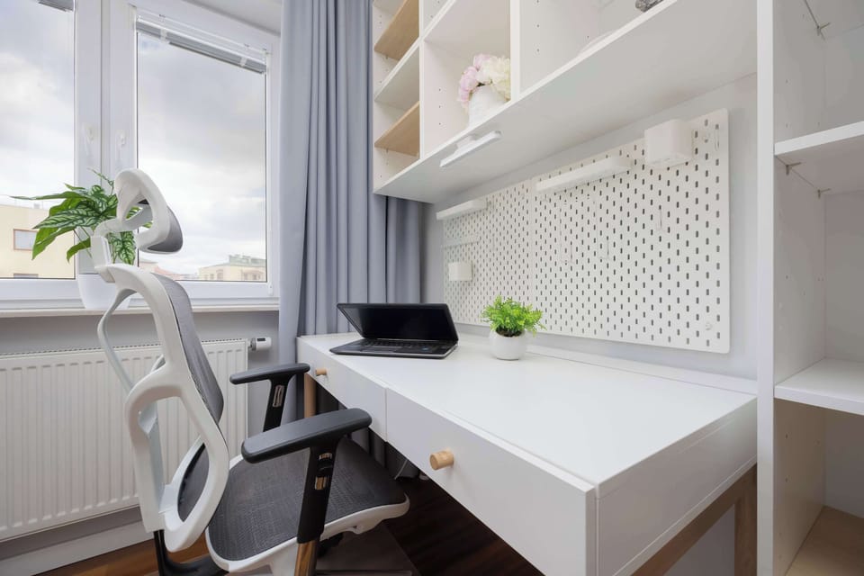 A bright desk by the window provides the perfect spot for work or study in natural light.