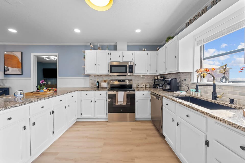 Kitchen: Shiny, sleek, and seaside chic includes stainless steel appliances plus a breakfast bar for four making this kitchen a perfect gathering spot.