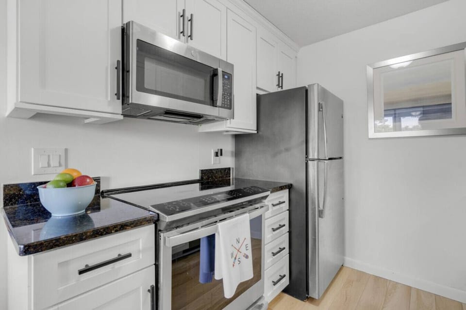 Modern kitchen with full-size appliances, bright lighting, and convenient cooking space.