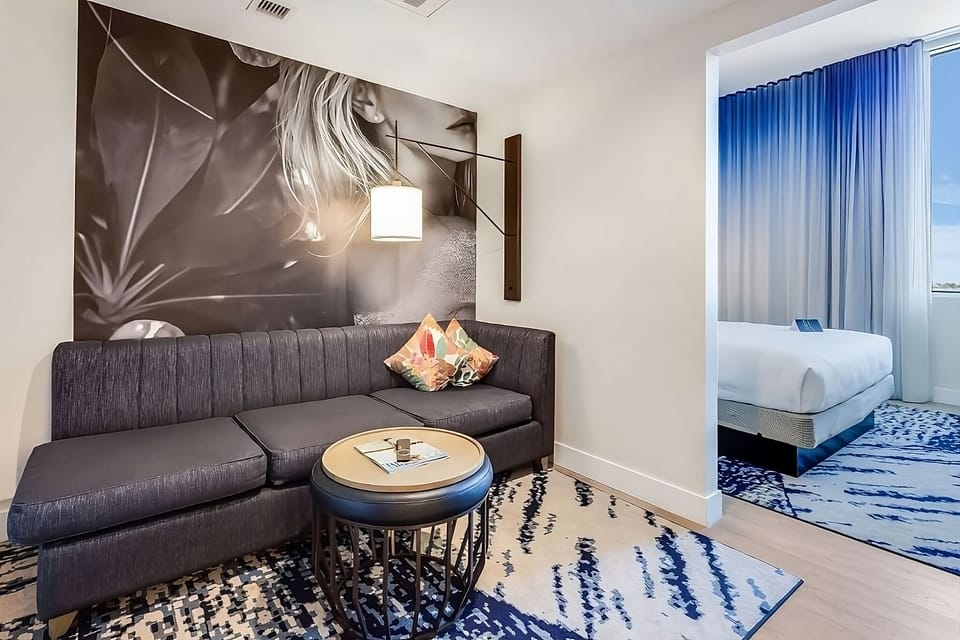 Stretch out on the plush sofa beside bold, artistic wall décor.