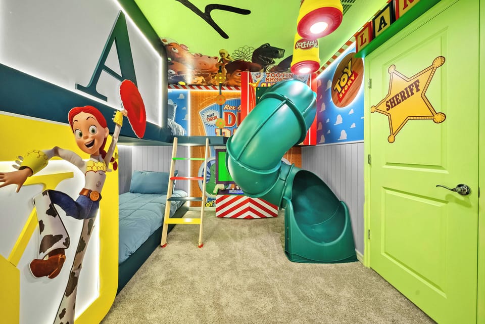 This vibrant kids' room boasts bright colors, playful decor, a fun slide, and a cozy bed, creating an energetic atmosphere that promises imaginative play and a delightful stay for younger guests.