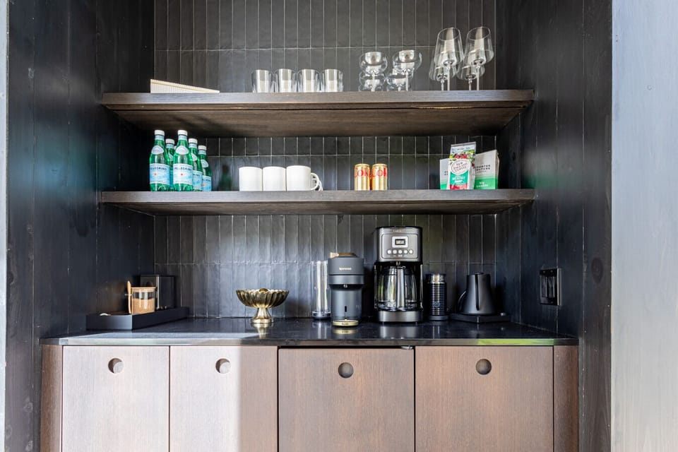 The coffee bar is filled with everything you need including a wine fridge