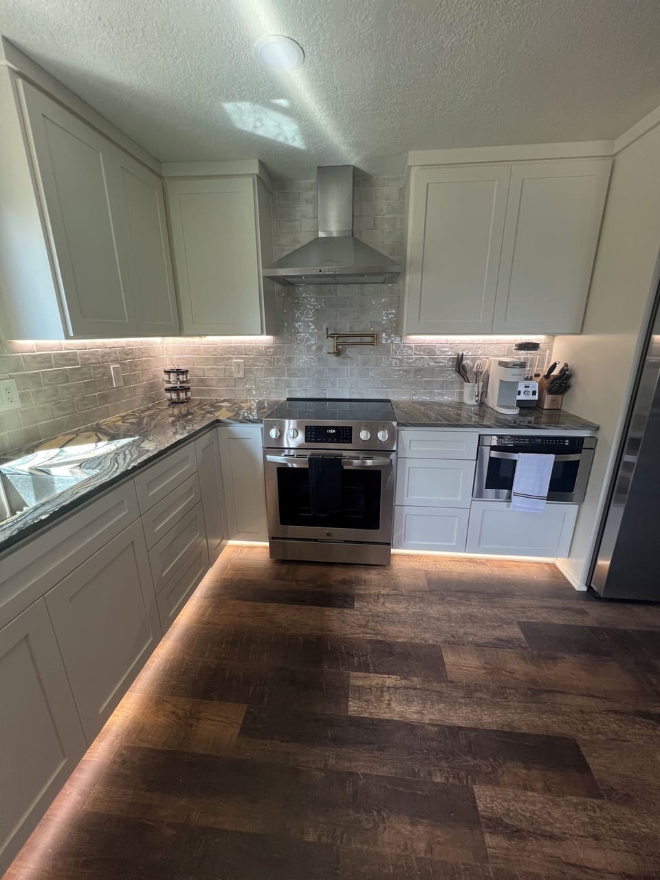 GOURMET KITCHEN- DIMMABLE UNDER CABINET AND TOE KICK LIGHTING.