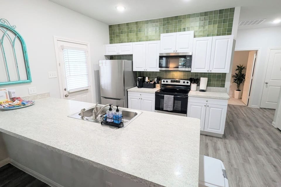 This fully stocked kitchen has a stove/oven, microwave, k-cup coffee maker, dishwasher, refrigerator, and plenty of space to make a delicious meal.  