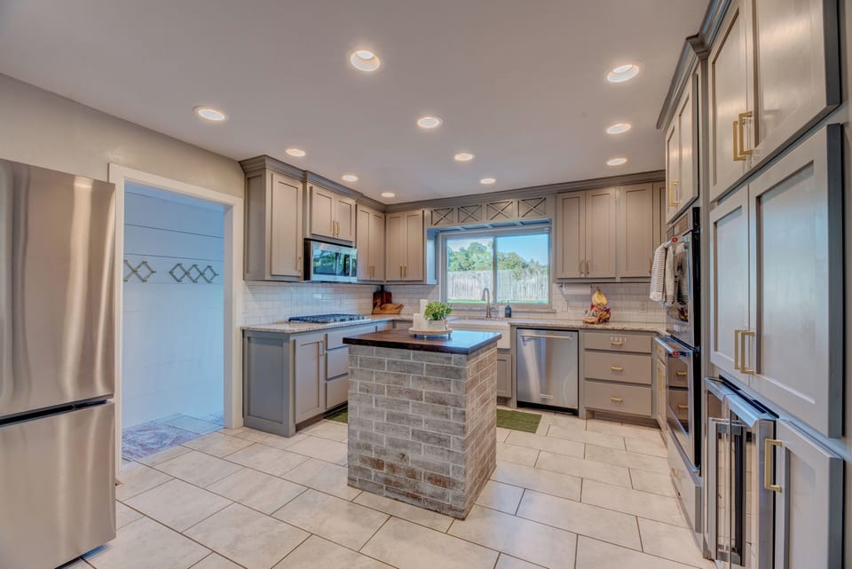 Chef's dream kitchen w/ gas range, double ovens, spices, and cooking oils. 