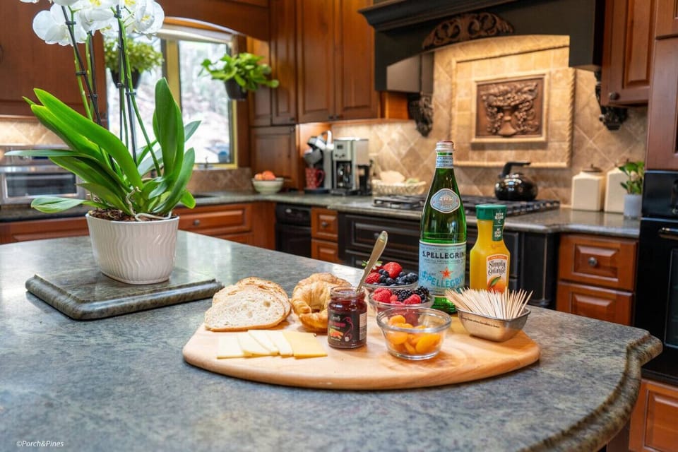 Modern kitchen with warm wood tones and all essentials for cooking, dining, and entertaining.