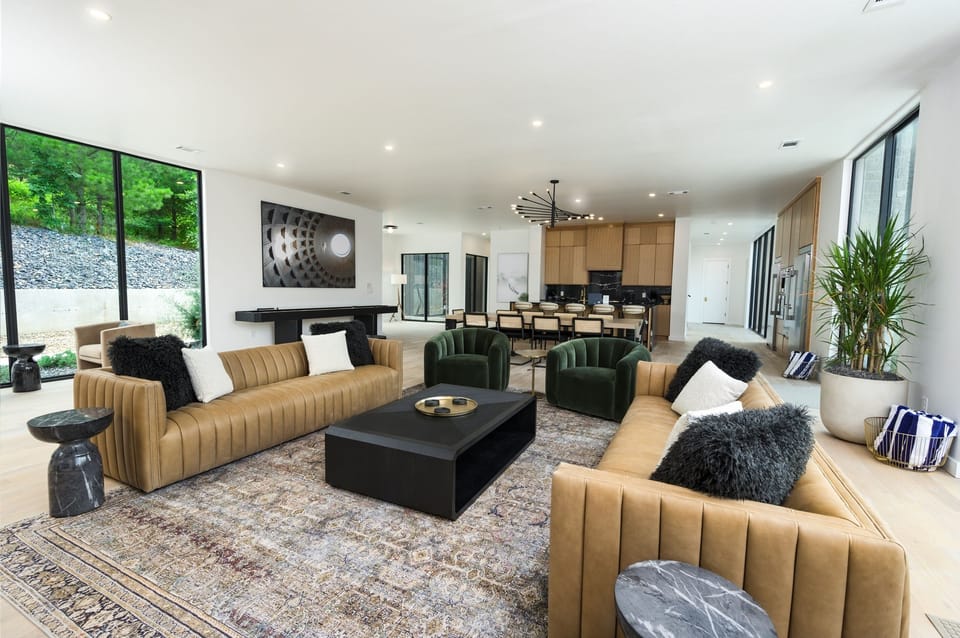 Living Room: Spacious lounge with modern decor, large windows, and inviting seating for gatherings!