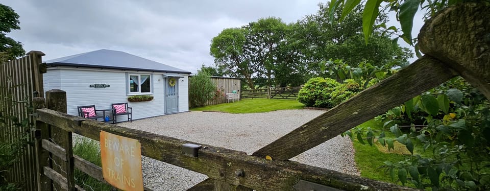 The entrance gate to The Signal Box showing front driveway with ample parking area