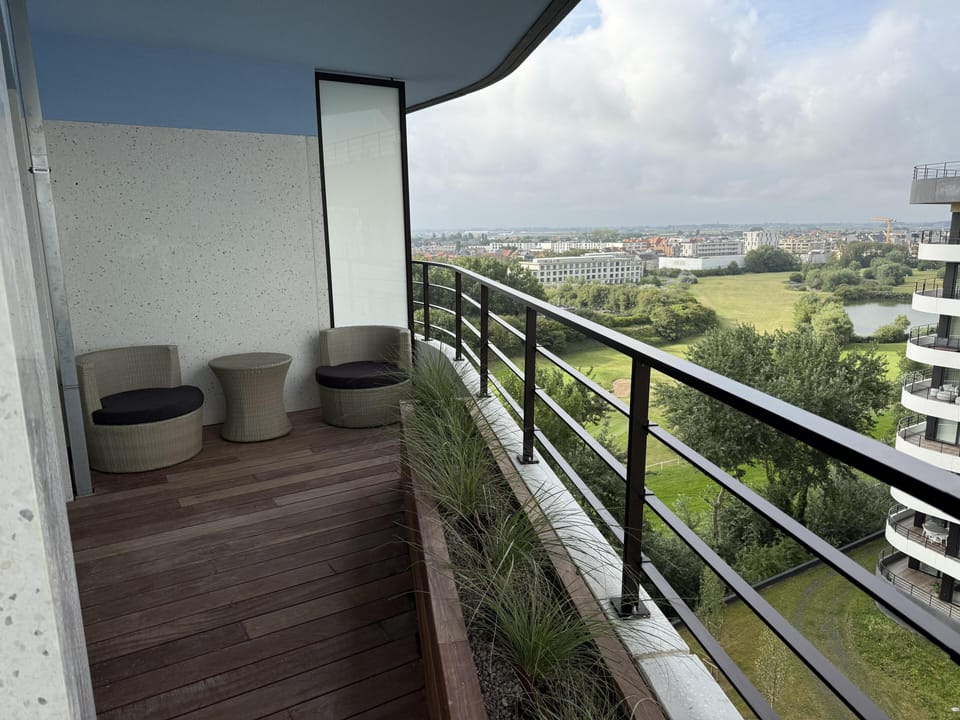 Balcony with chairs, enjoy peaceful mornings overlooking the green view.