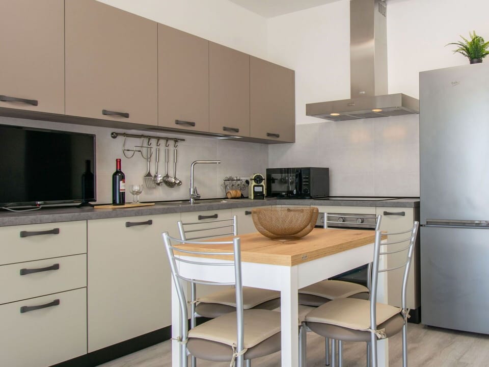 Furniture, Kitchen, Cabinetry, Countertop, Kitchen Appliance, Interior Design, Flooring, Wood, Major Appliance, Chair