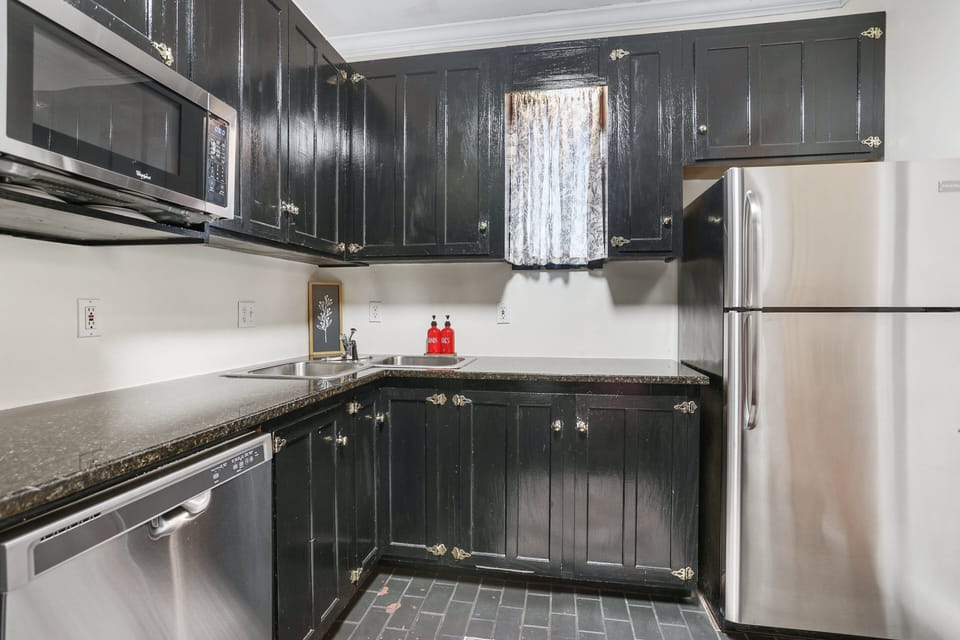 Rich black cabinetry adds depth and character, blending seamlessly with the home's historic charm.