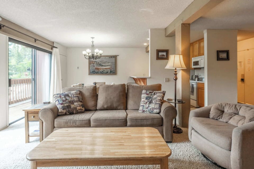 Cozy living room w/ smart TV, fireplace, sofa bed, & balcony access