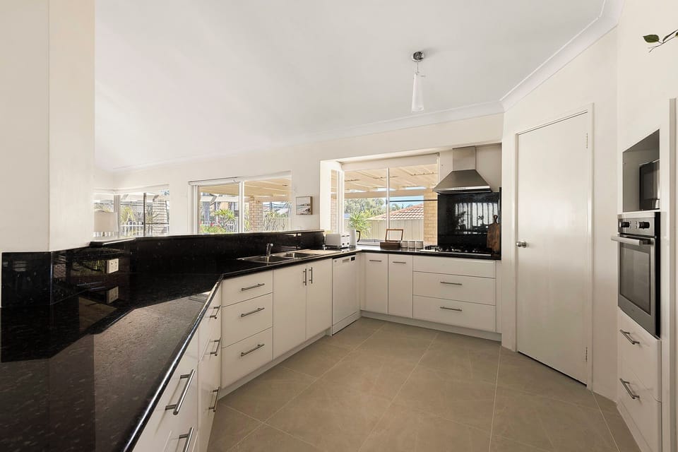 Kitchen with toaster, Kettle, fridge, rice cooker and microwave 
