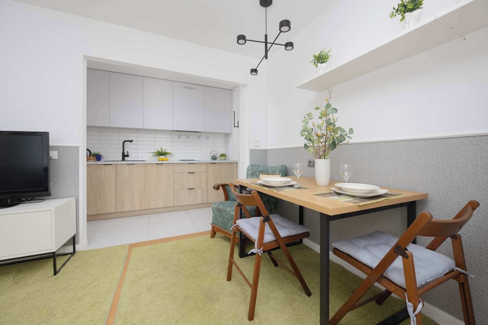 The dining area with designer chairs and a hanging lamp creates a welcoming space for shared meals and gatherings.