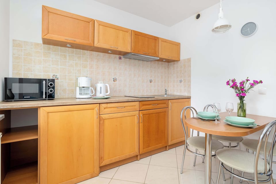 The sleek design of the kitchenette blending seamlessly with the living area.